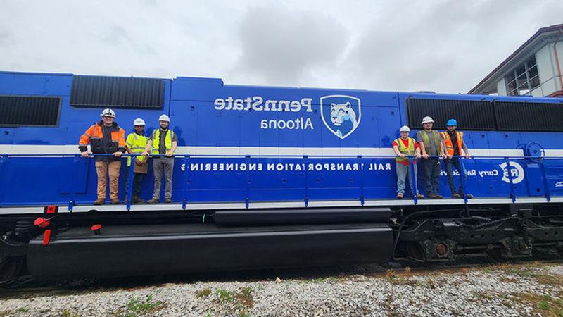 Penn State Altoona Rail Transportation Engineering students pose on the PSU 2020 locomotive.